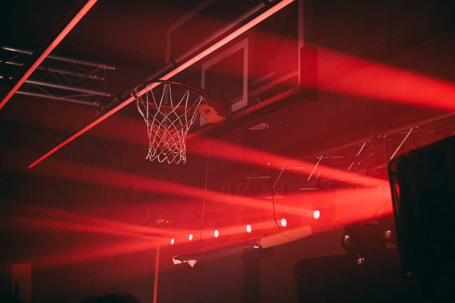 Detail shot of the basketball hoop with streams of red light at the main stage of Sustain-Release.