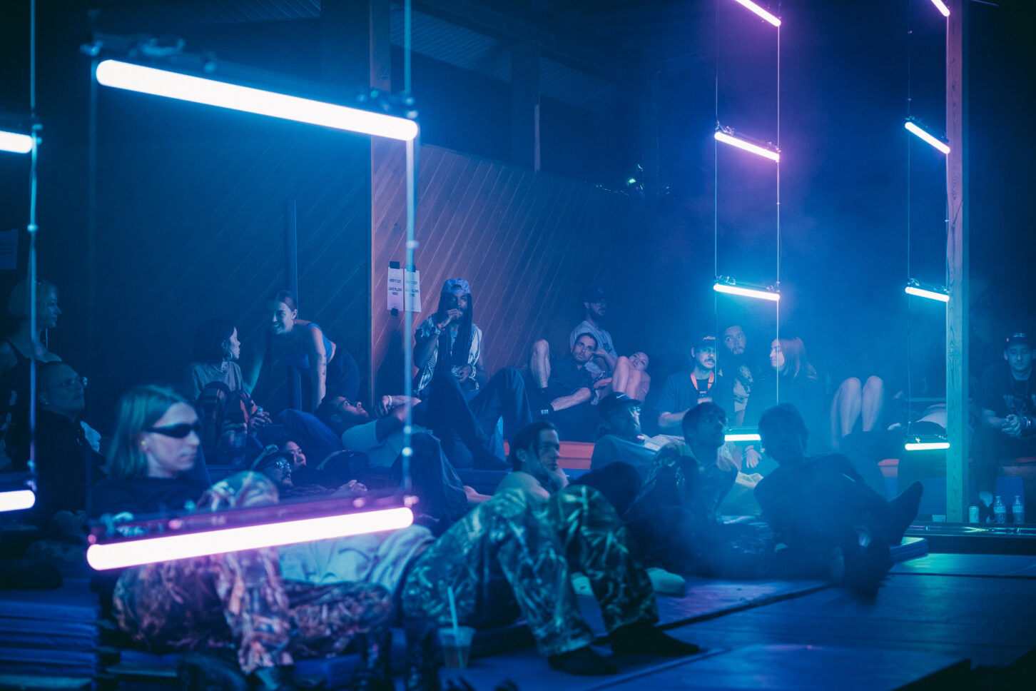 Listeners lounge surrounded by neon lights at the Bossa Lounge of Sustain-Release.