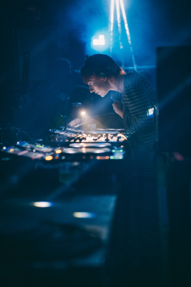 CCL DJing under the glow of the lights at the Sustain-Release Grove.