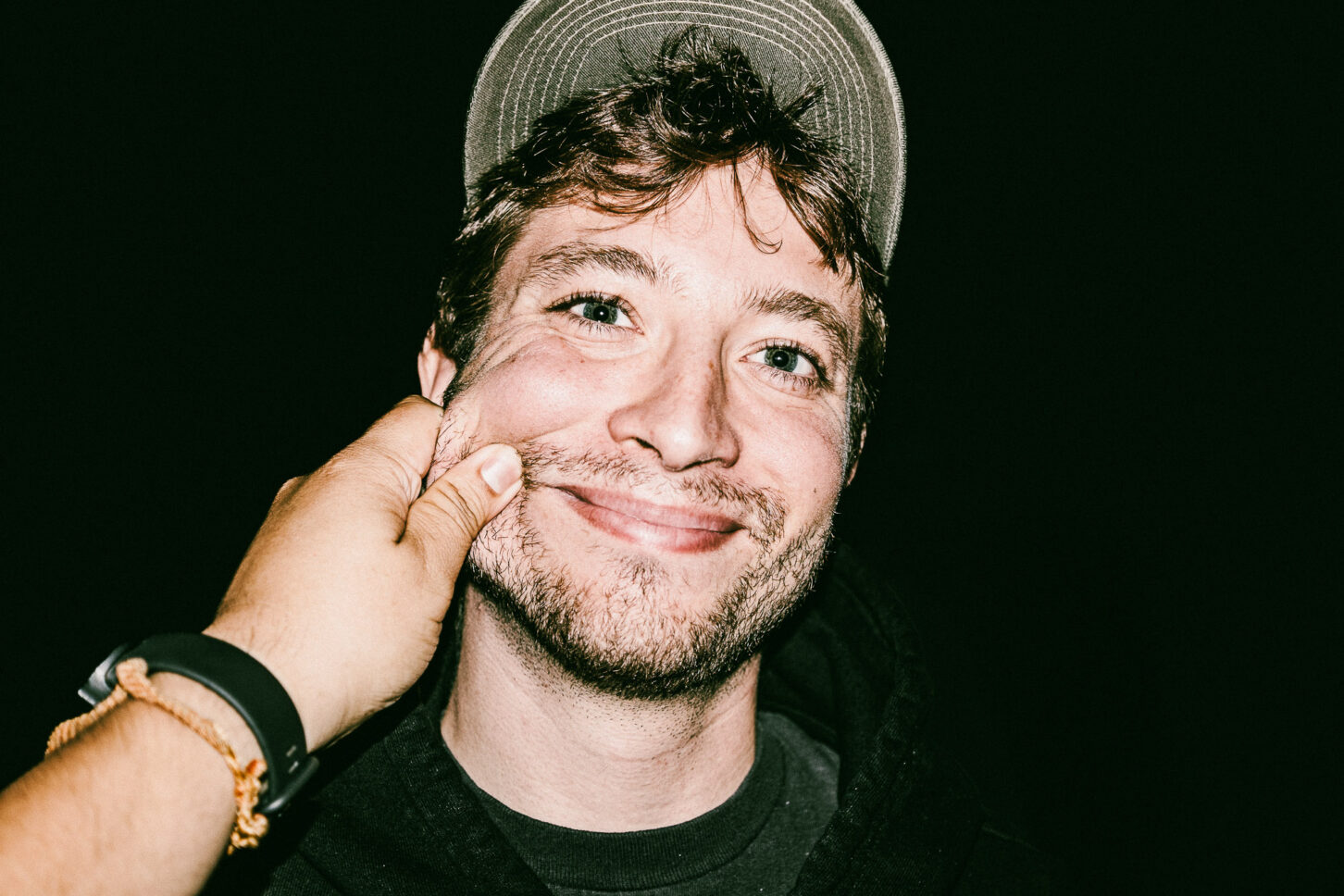 Close-up, raw portrait of a subject with a look of pure surprise, highlighting the high-energy and candid nature of the 'Cheeky Bastards' collection.