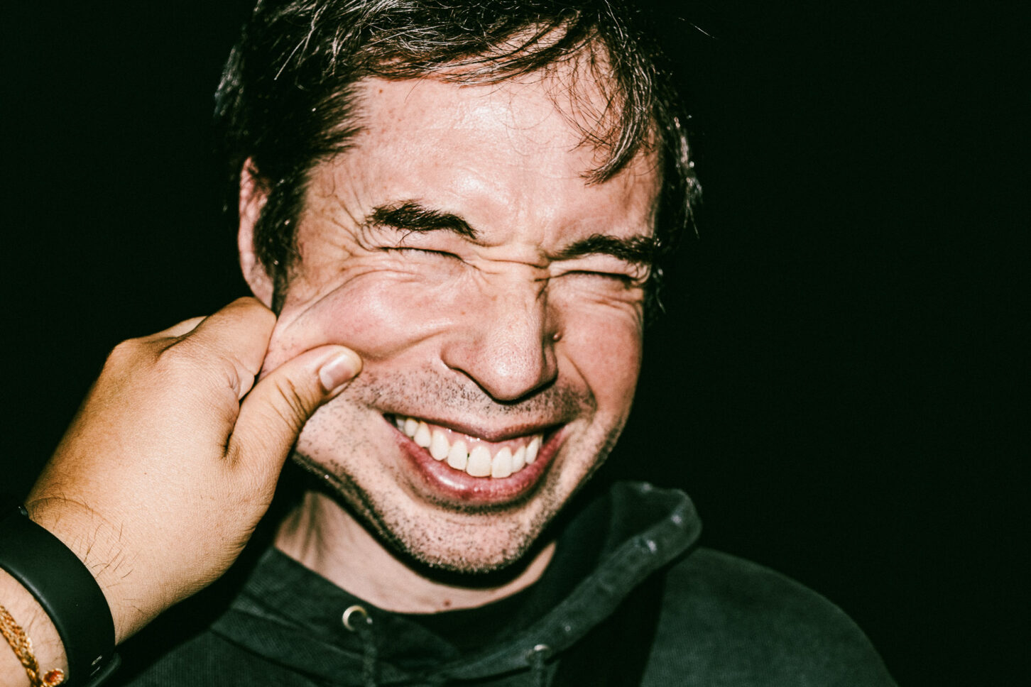 Close-up, raw portrait of a subject with a look of pure surprise, highlighting the high-energy and candid nature of the 'Cheeky Bastards' collection.