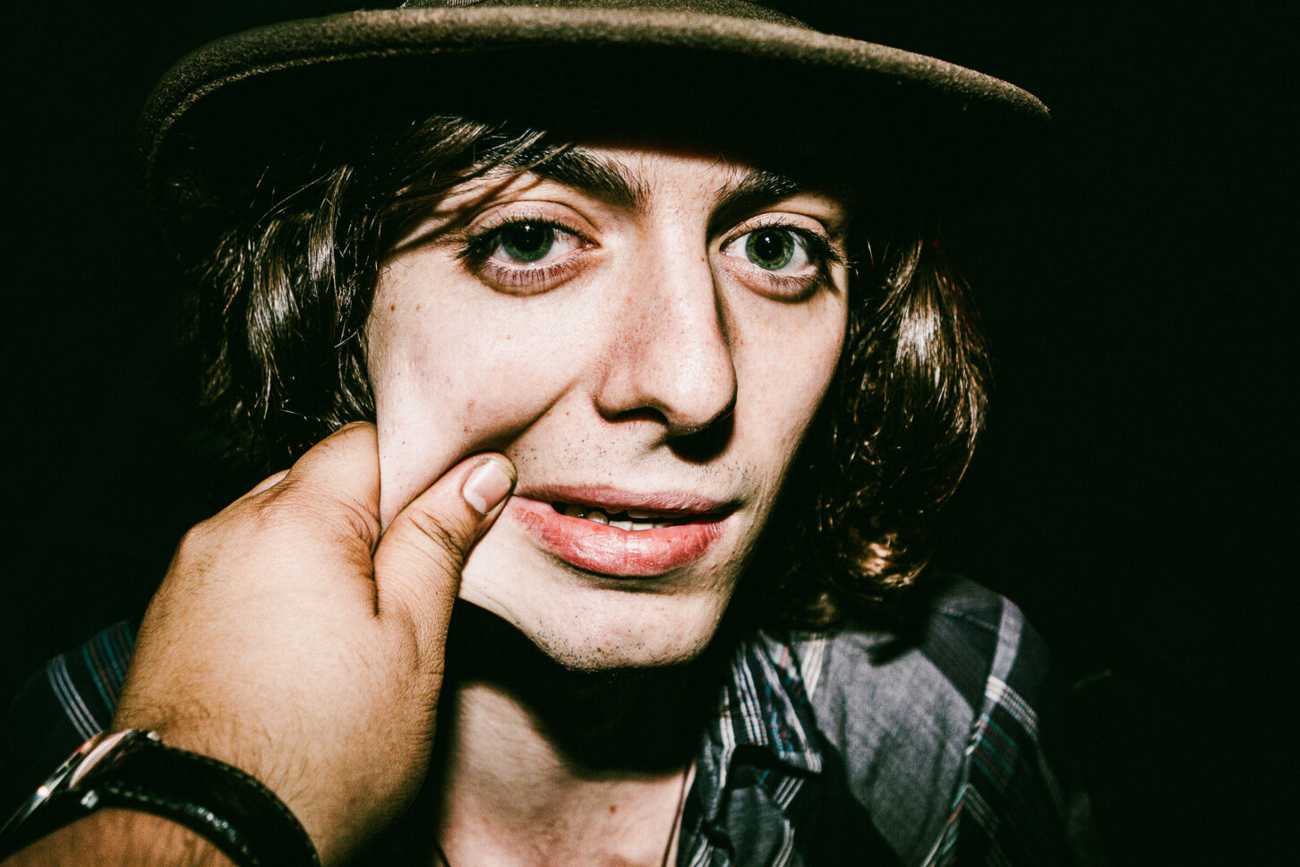 Close-up, raw portrait of a subject with a look of pure surprise, highlighting the high-energy and candid nature of the 'Cheeky Bastards' collection.