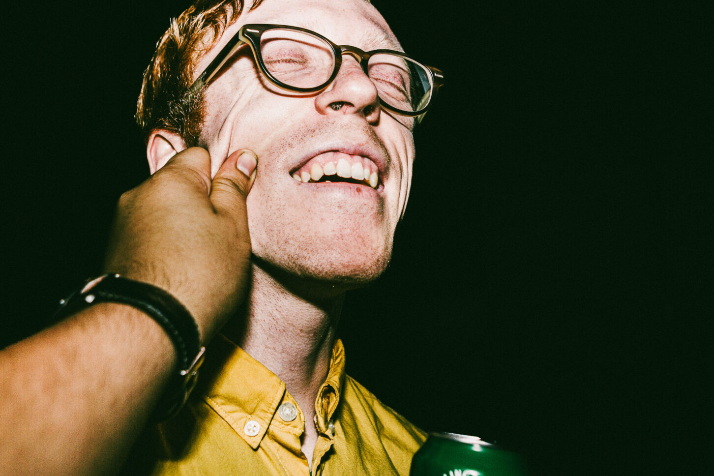 A person tilting their head away, eyes wide with feigned indignation, captured in the raw, direct flash style of 'Cheeky Bastards'.