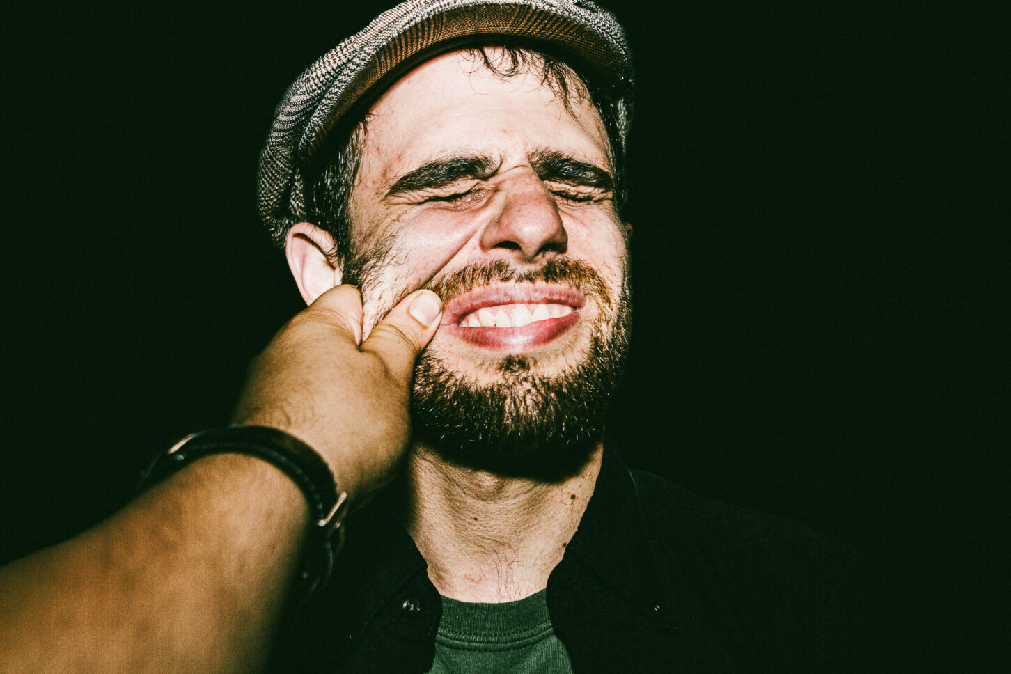 A subject clenching their teeth in a mock-angry grimace, adding a rough, gritty texture to the 'Cheeky Bastards' portrait series.