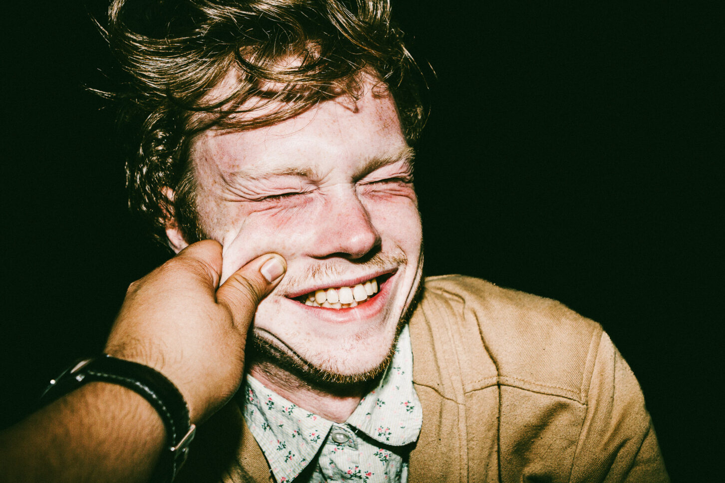 A person scrunching their nose in a playful "ew" expression, captured in high-contrast black and white for the 'Cheeky Bastards' collection.